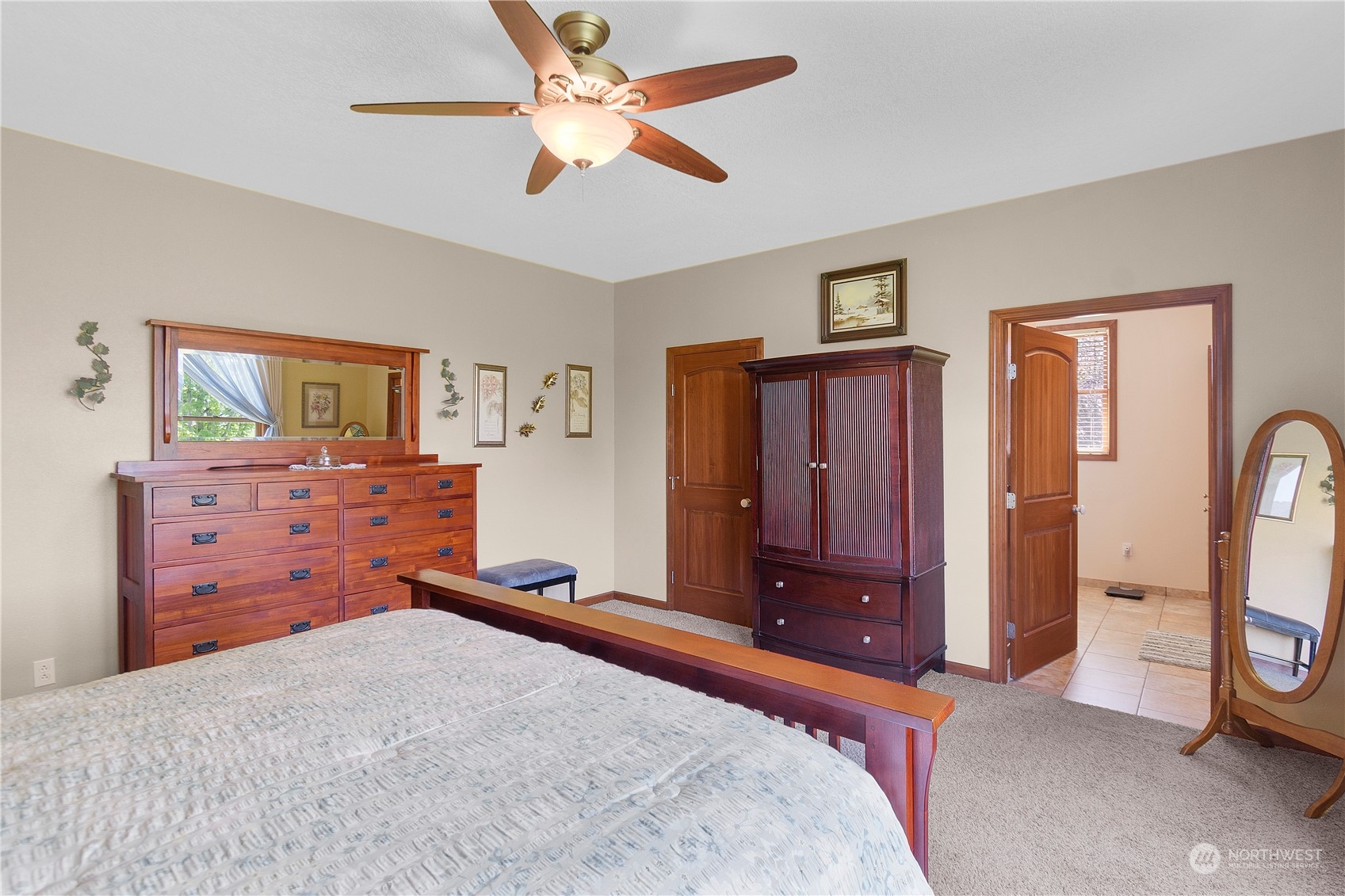 285 West Birnie Slough Road Cathlamet, WA 98612 - Photo 17 of 40 a bedroom with a bed and a chandelier