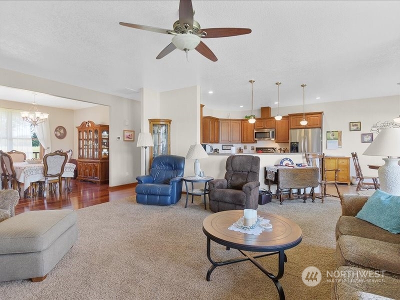 285 West Birnie Slough Road Cathlamet, WA 98612 - Photo 10 of 40 a living room with furniture kitchen view and a chandelier