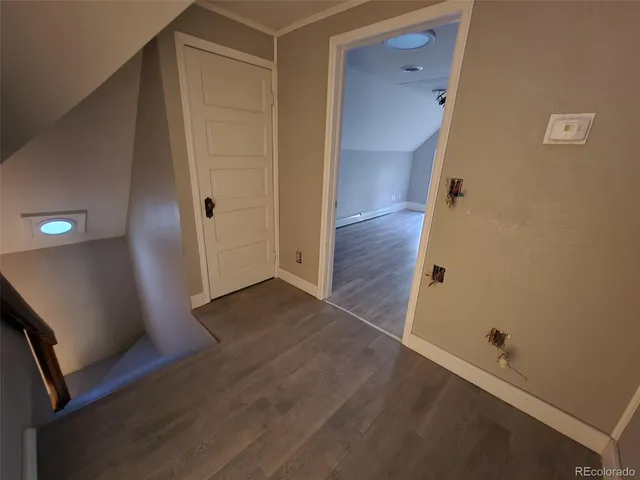 an empty room with wooden floor and closet