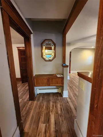 a view of a hallway with wooden floor and a hallway