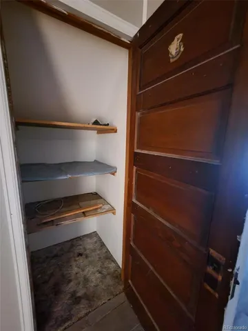 a view of walk in closet with empty racks
