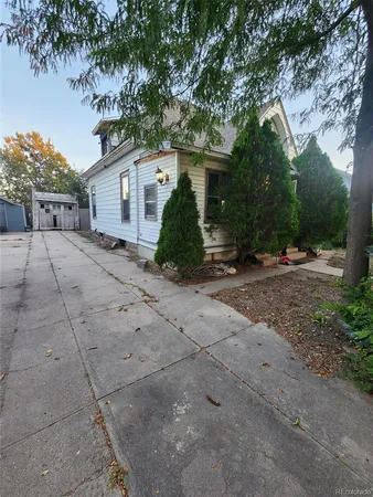 a view of a house with a tree in front of it