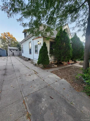 a view of a house with a tree in front of it
