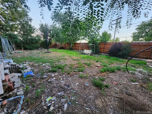a view of a backyard with large trees