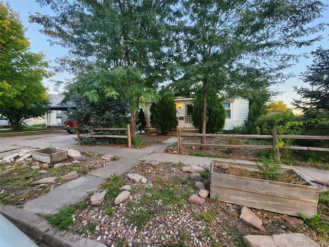 a view of a backyard with wooden fence