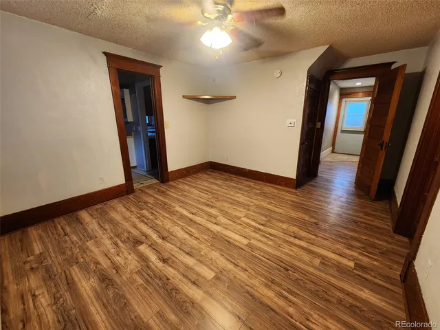 a view of a room with wooden floor and staircase