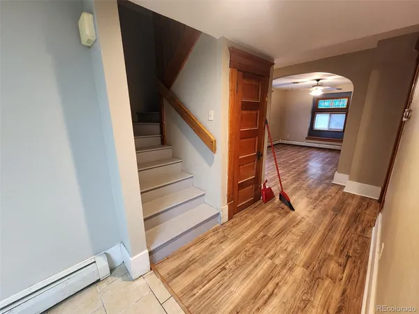 a view of entryway and hall with wooden floor