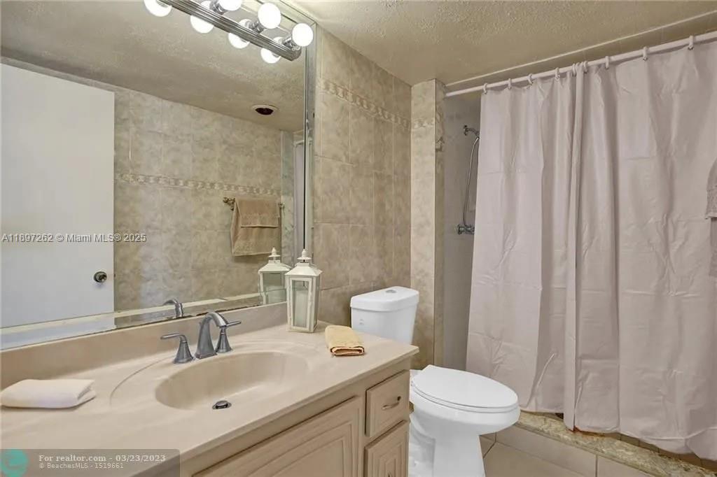 7051 Environ Boulevard, Unit 337 Lauderhill, FL 33319 - Photo 12 of 15 a bathroom with a sink toilet and shower