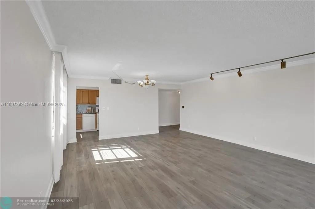 7051 Environ Boulevard, Unit 337 Lauderhill, FL 33319 - Photo 2 of 15 a view of empty room with wooden floor and window