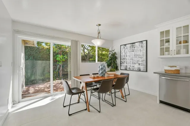 a dining room with a wooden table and chairs