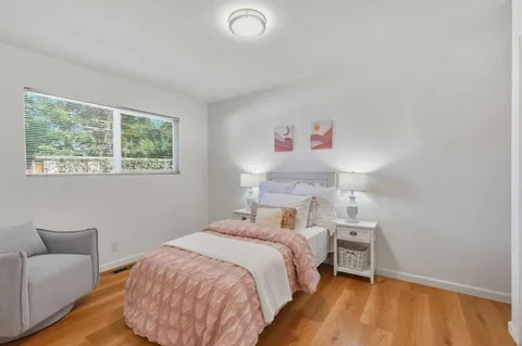 a bedroom with a bed and a couch