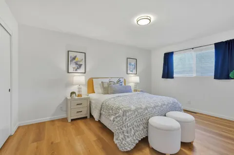 a bedroom with a bed and a couch