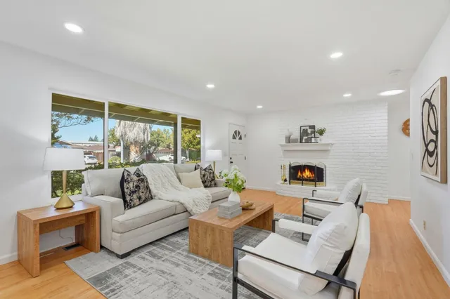 a living room with furniture and a painting on the wall