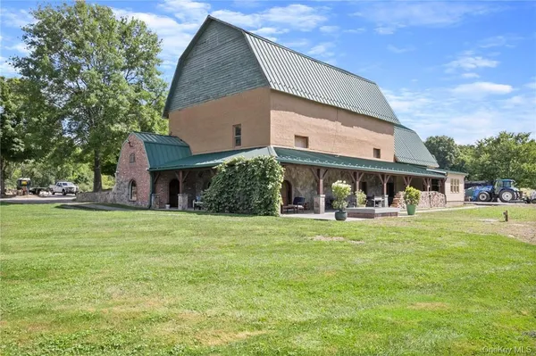 a view of a house with a yard and sitting area