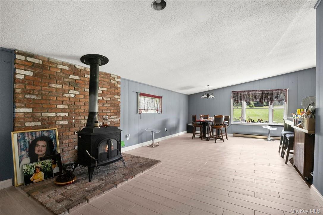 55 Daley Road Poughkeepsie, NY 12603 - Photo 32 of 38 a living room with furniture and a fireplace