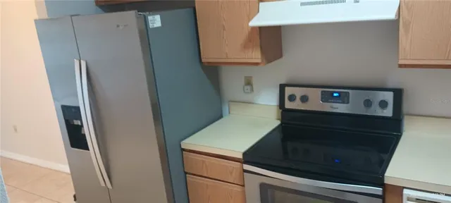 a view of a refrigerator in kitchen