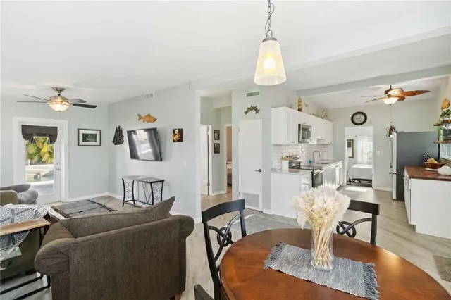 a living room with furniture a window and wooden floor