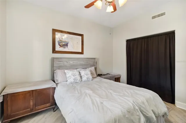 a bedroom with a bed and a chandelier