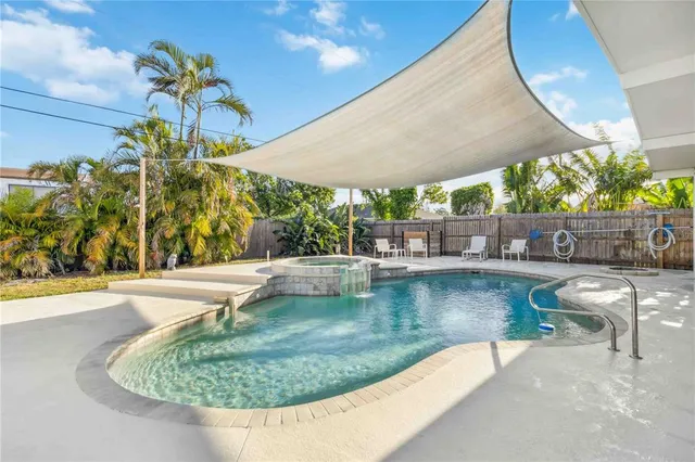 a view of a patio with table and chairs potted plants with wooden floor