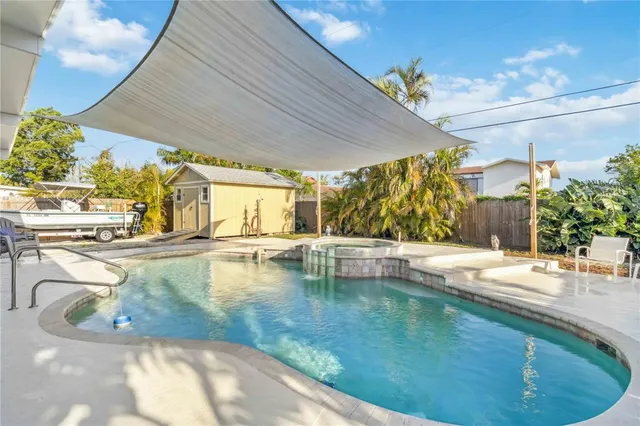 a view of a swimming pool with outdoor seating