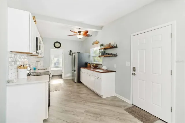 a kitchen with stainless steel appliances a sink stove and refrigerator