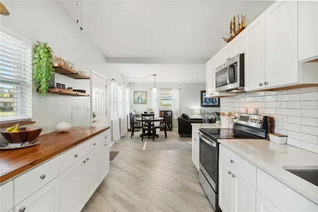 a living room with furniture and painting on the wall