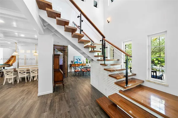 a kitchen with stainless steel appliances granite countertop a stove and a view of living room