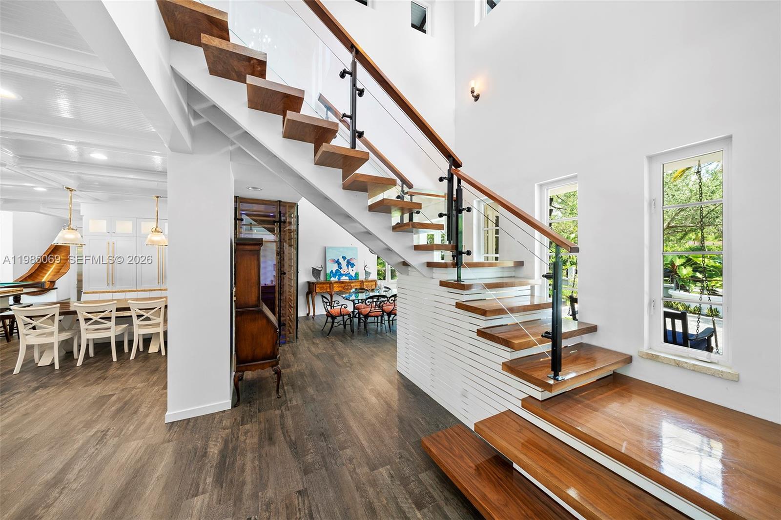 6700 Southwest 132nd Street Pinecrest, FL 33156 - Photo 13 of 99 a view of entryway and hall with wooden floor