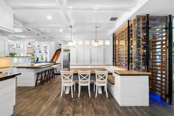 a kitchen with kitchen island granite countertop appliances cabinets and a counter top space