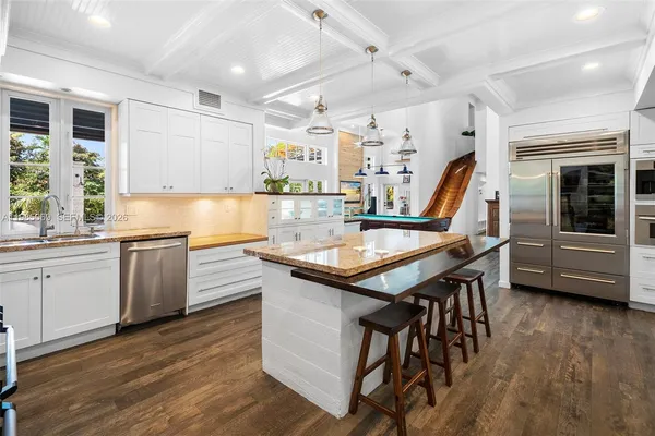 a room with lots of furniture and a wooden floor