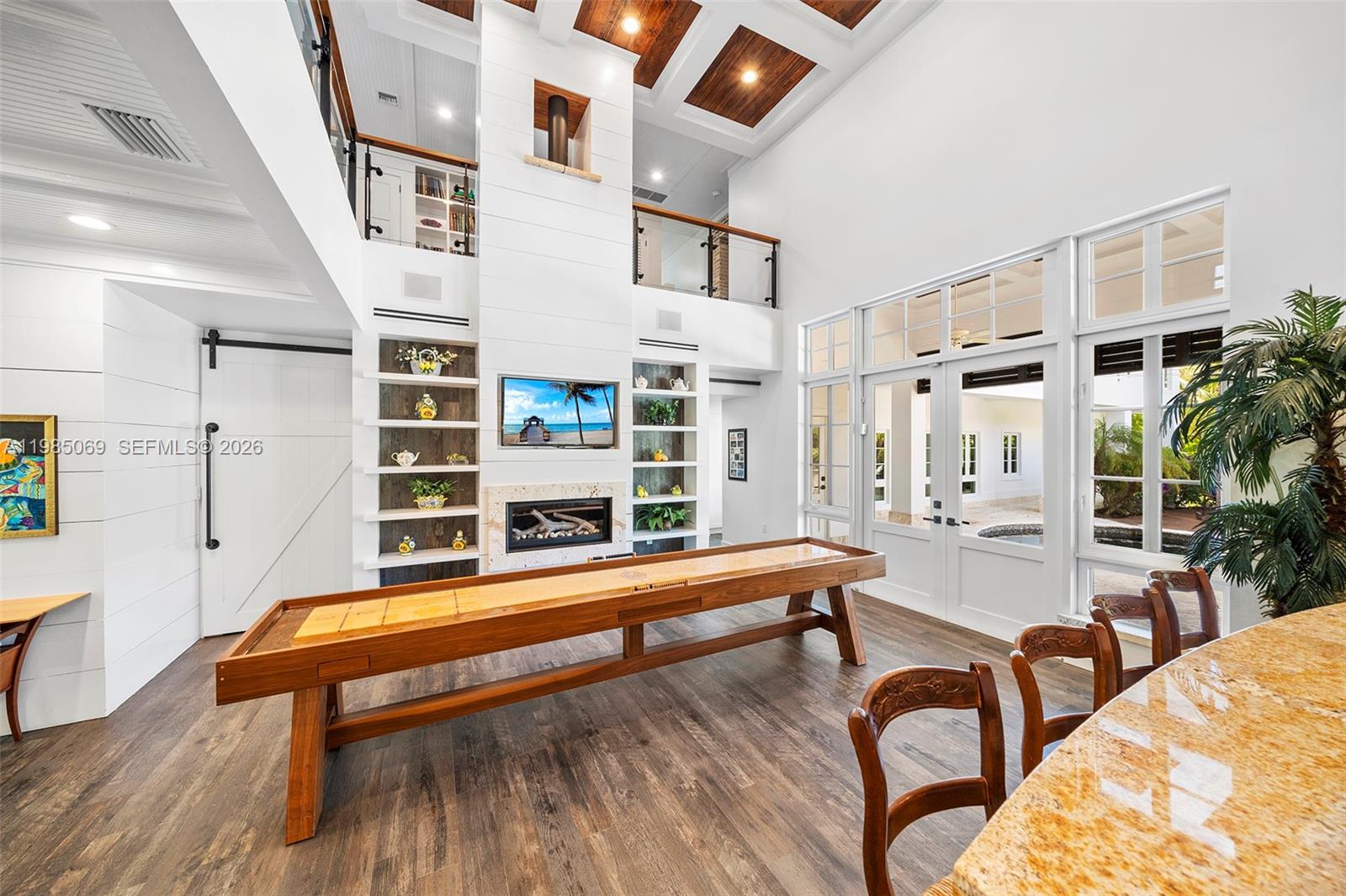 6700 Southwest 132nd Street Pinecrest, FL 33156 - Photo 33 of 99 a reading room with furniture and wooden floor