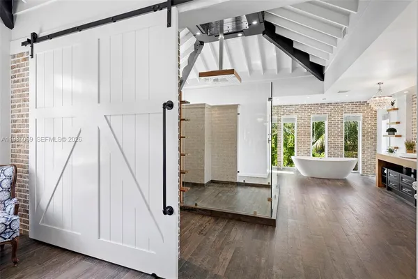 a living room with hard wood flooring and furniture
