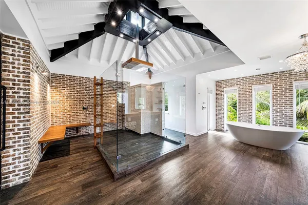 a view of a hallway and a dining room with wooden floor