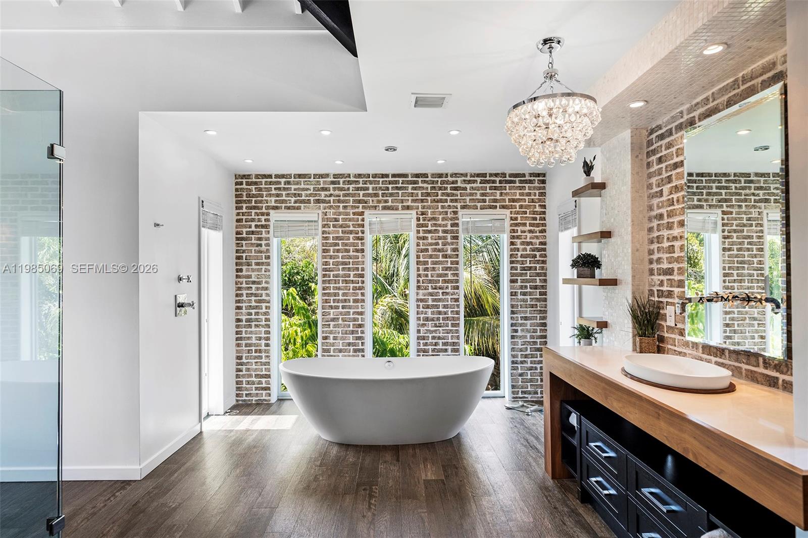 6700 Southwest 132nd Street Pinecrest, FL 33156 - Photo 40 of 99 a spacious bathroom with a granite countertop sink a toilet a window and shower