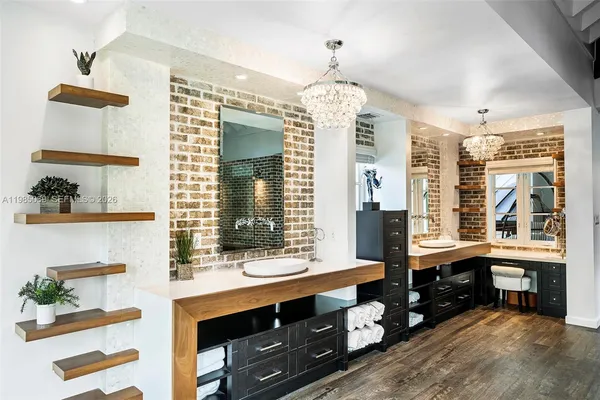 a view of a white house with a yard and potted plants