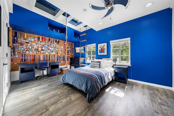 a front view of a house with a garden and trees