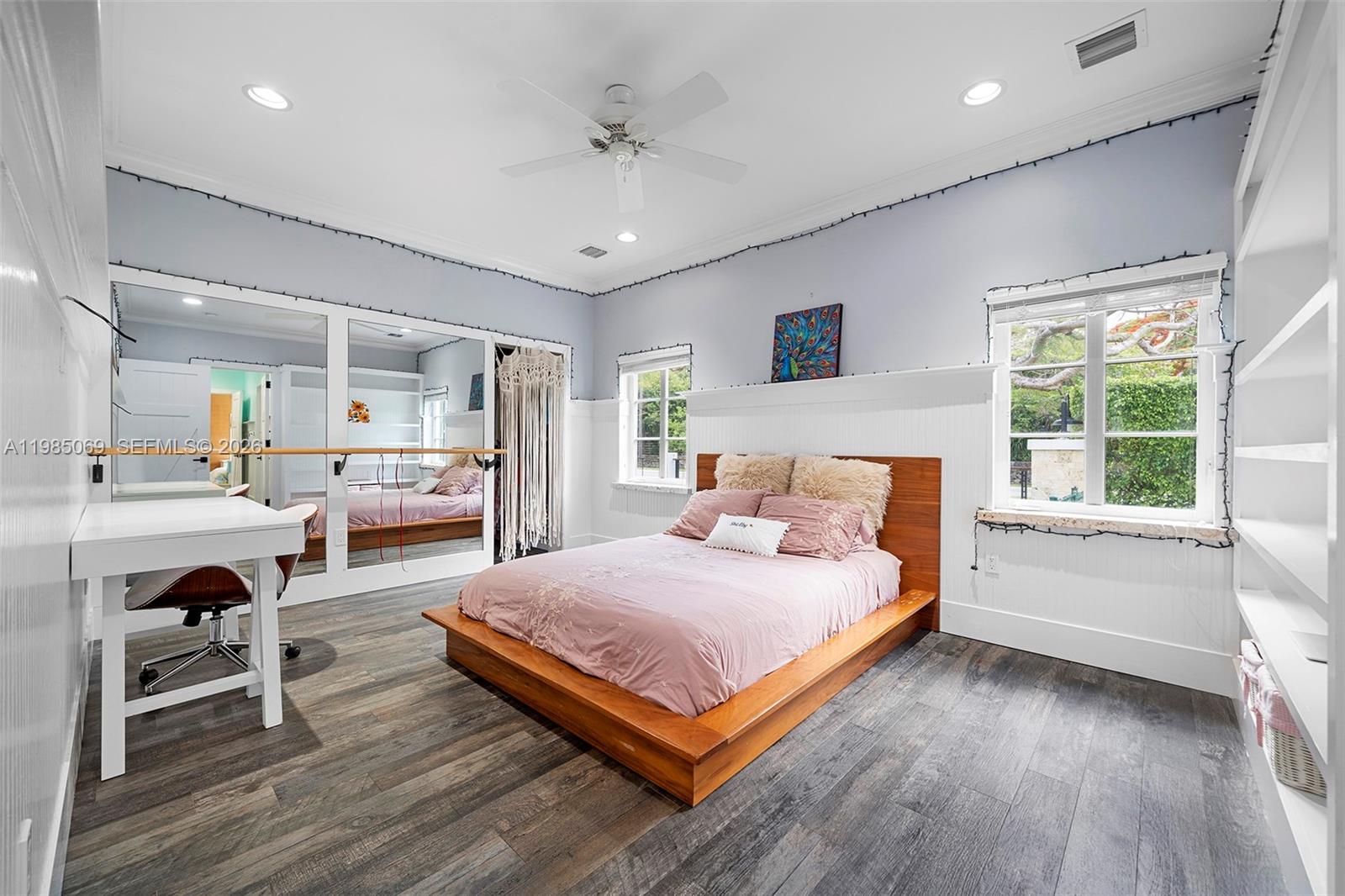 6700 Southwest 132nd Street Pinecrest, FL 33156 - Photo 47 of 99 a bedroom with a large bed and a wooden floor