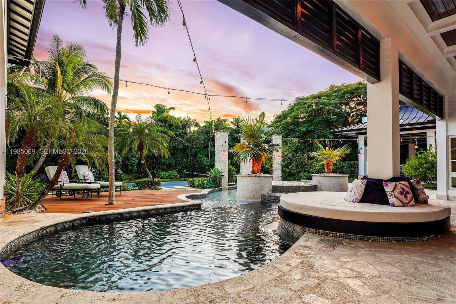 6700 Southwest 132nd Street Pinecrest, FL 33156 - Photo 5 of 99 a view of a swimming pool with a patio