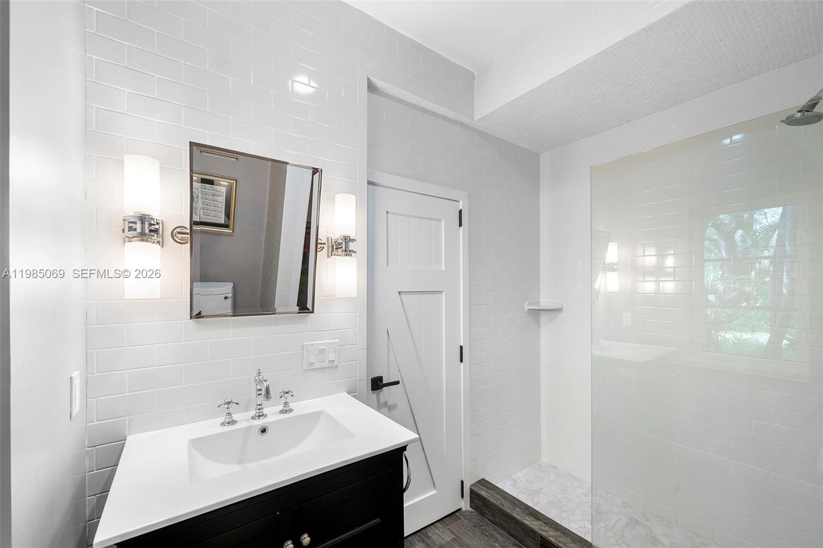 6700 Southwest 132nd Street Pinecrest, FL 33156 - Photo 57 of 99 a bathroom with a sink shower and a mirror