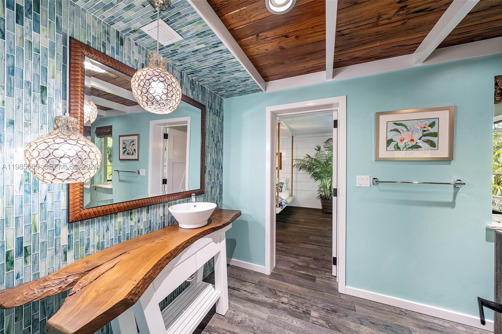 6700 Southwest 132nd Street Pinecrest, FL 33156 - Photo 73 of 99 a view of a hallway and a dining room with wooden floor