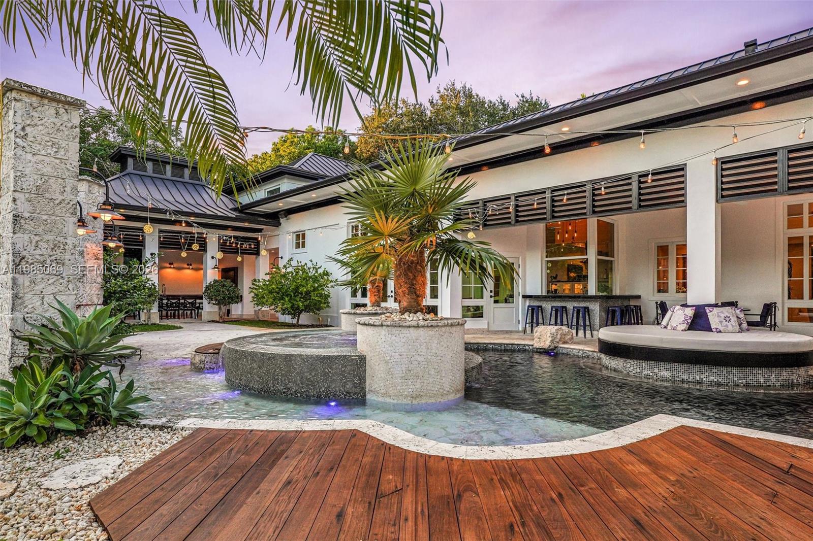 6700 Southwest 132nd Street Pinecrest, FL 33156 - Photo 84 of 99 a view of a house with swimming pool patio and sitting area
