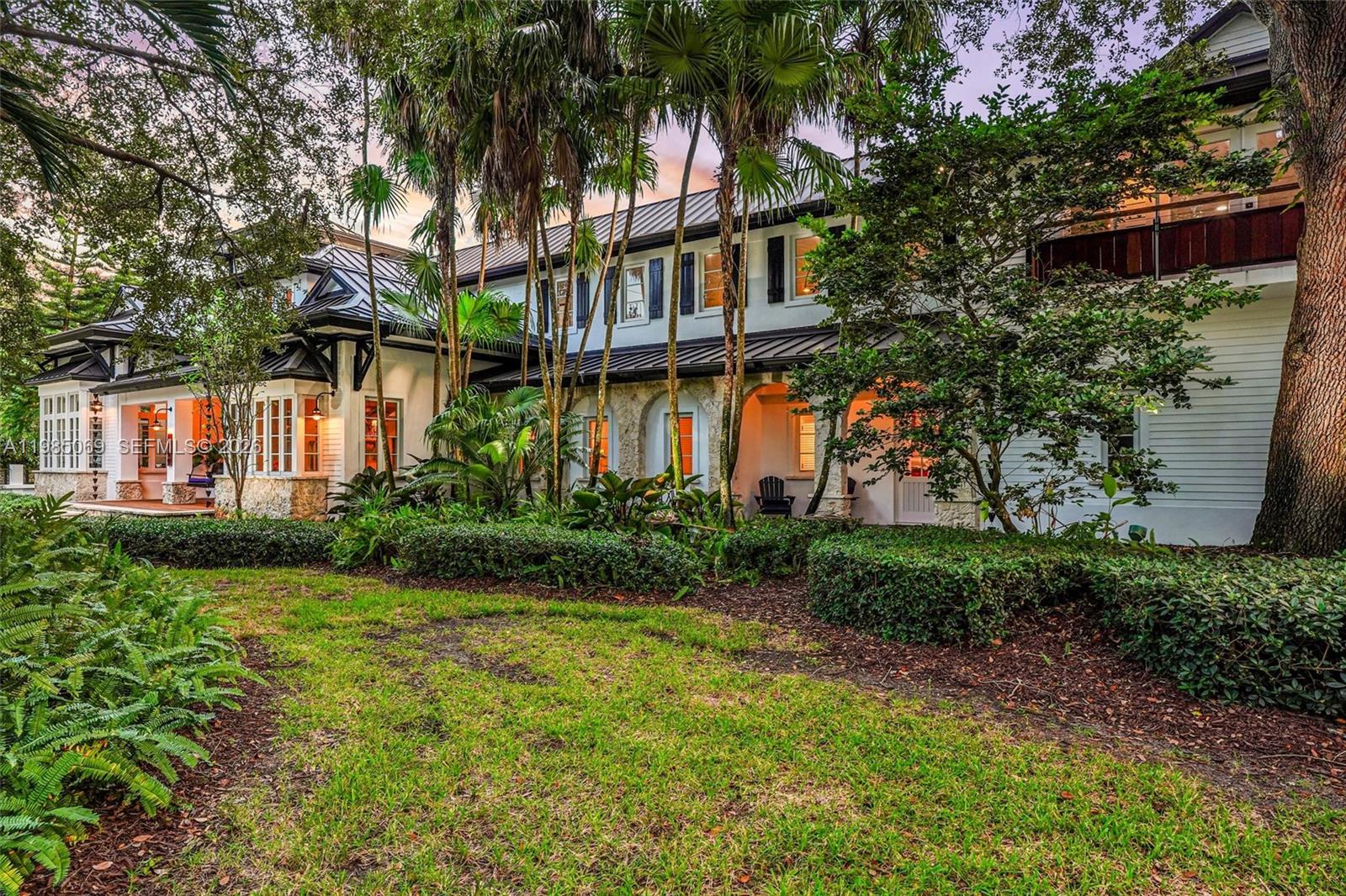 6700 Southwest 132nd Street Pinecrest, FL 33156 - Photo 88 of 99 a view of a house with a yard and plants