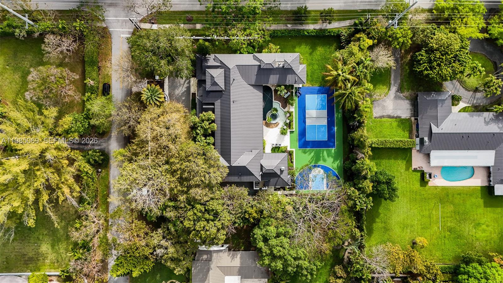6700 Southwest 132nd Street Pinecrest, FL 33156 - Photo 92 of 99 an aerial view of a house with swimming pool and garden