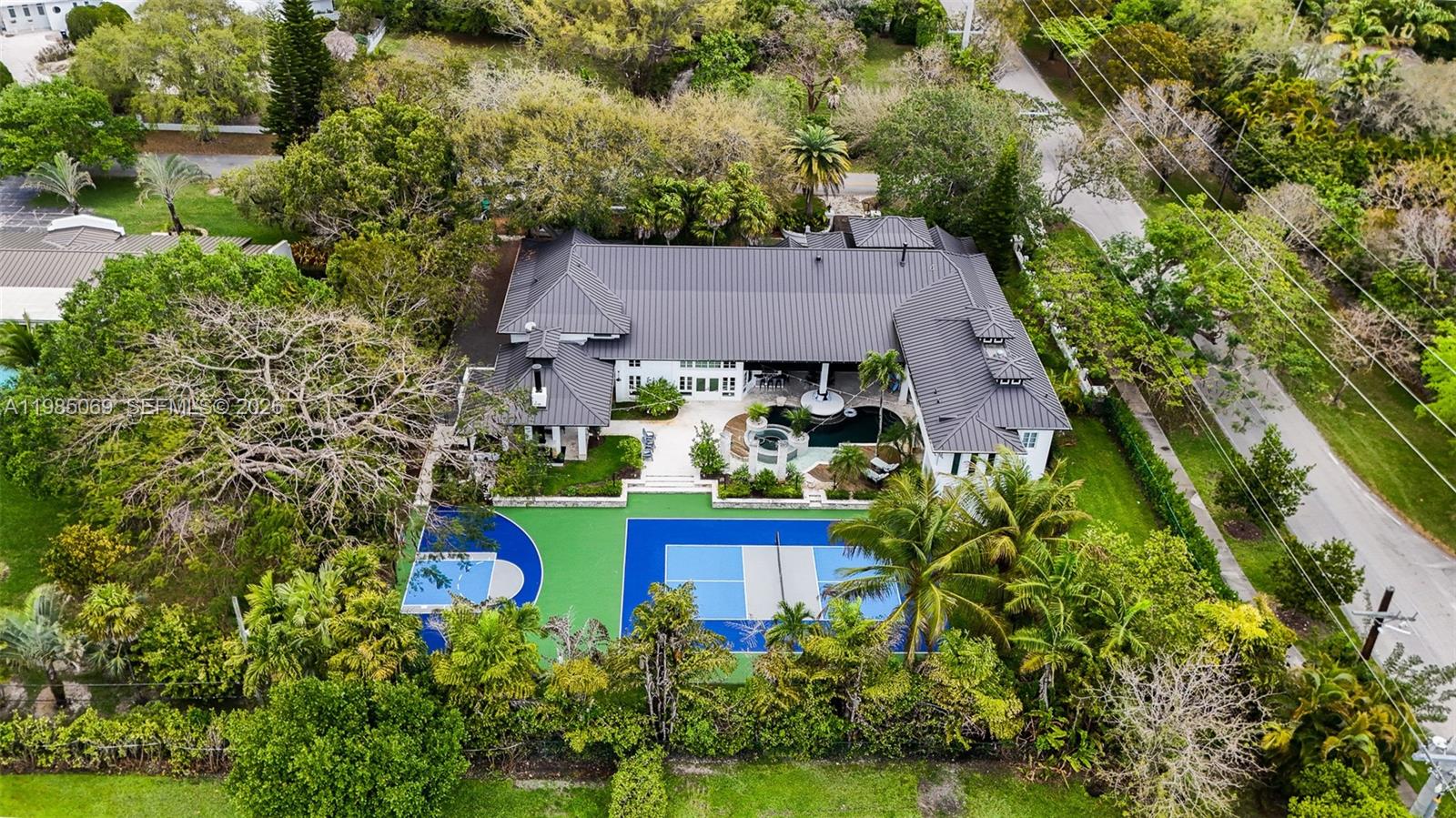 6700 Southwest 132nd Street Pinecrest, FL 33156 - Photo 93 of 99 an aerial view of a house with yard swimming pool and outdoor seating