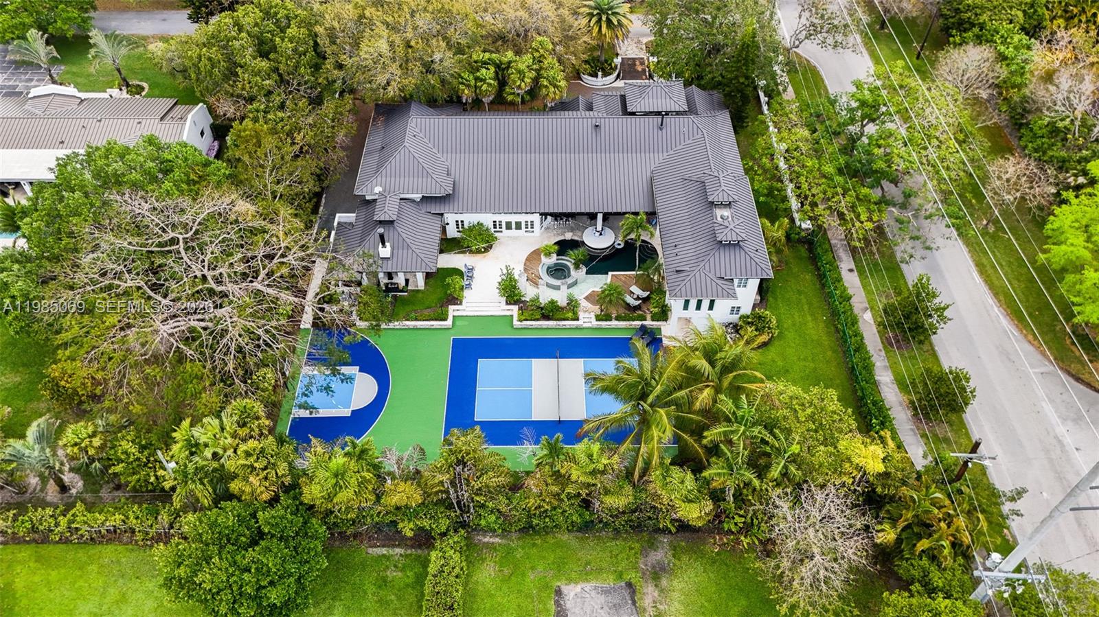 6700 Southwest 132nd Street Pinecrest, FL 33156 - Photo 94 of 99 an aerial view of a house with yard swimming pool and outdoor seating