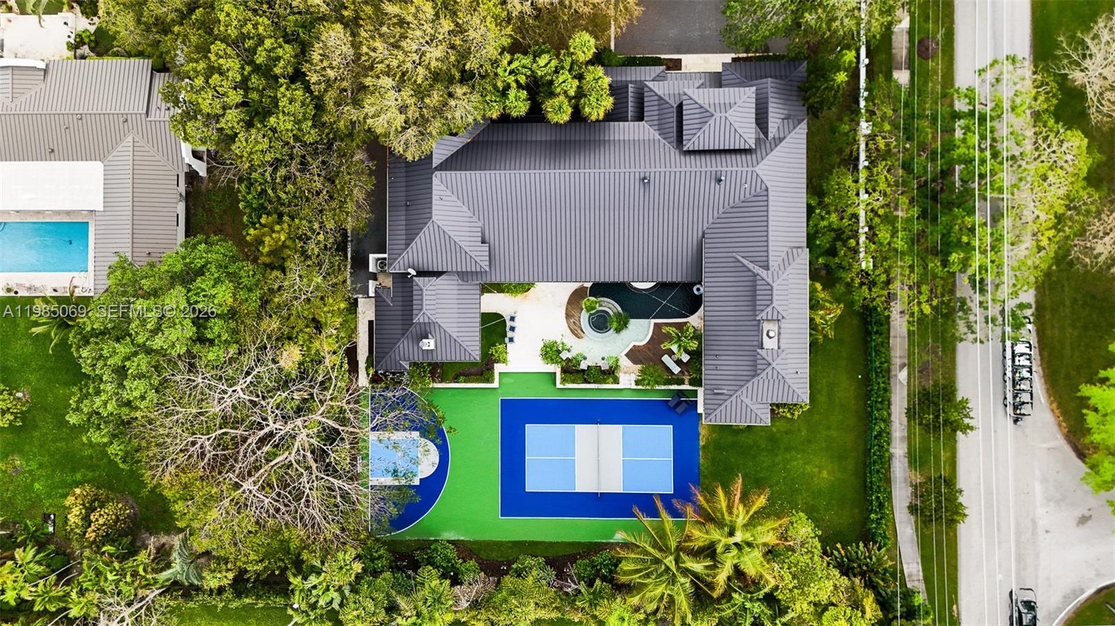 6700 Southwest 132nd Street Pinecrest, FL 33156 - Photo 96 of 99 an aerial view of a house with a yard and garden