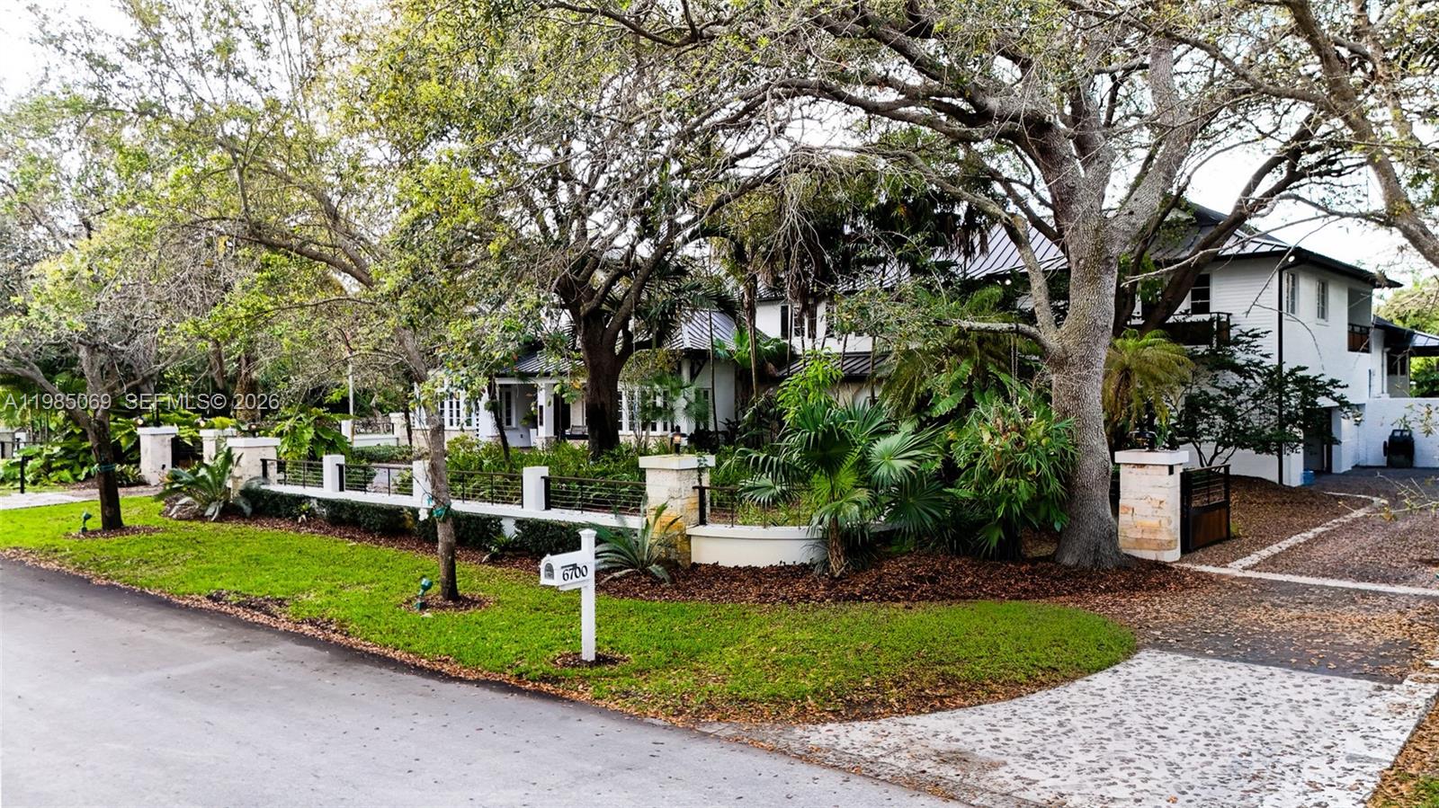 6700 Southwest 132nd Street Pinecrest, FL 33156 - Photo 97 of 99 a view of a house with a yard and tree s