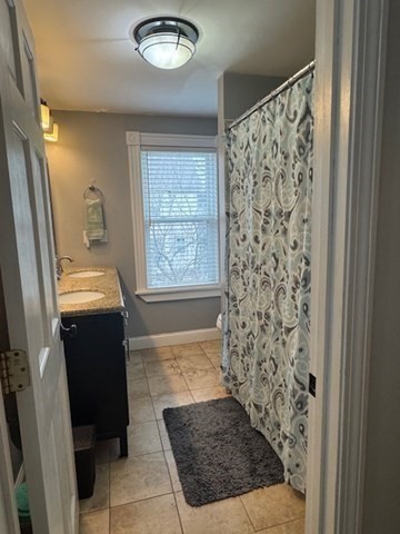 30 Parker Street Lexington, MA 02421 - Photo 11 of 11 a view of a hallway to a livingroom with furniture and windows