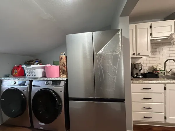 a utility room with closet dryer and washer