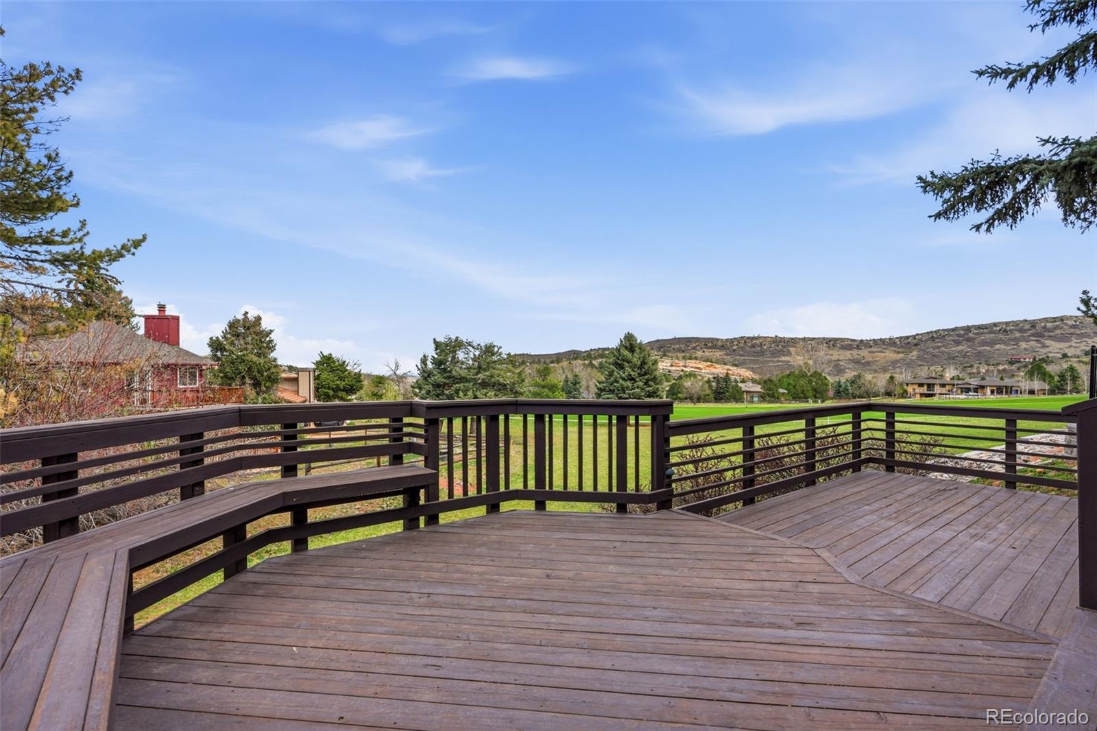 15743 Wedge Way Morrison, CO 80465 - Photo 12 of 48 a view of a terrace with wooden benches